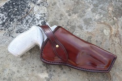 Field Holster shown with button stud for retention strap closure.