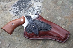 Field Holster in mahogany with black shark trim and black cowhide strap.  Border stamping was also added along with a rear sight guard.