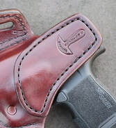 Close up view of a reinforced slide guard on a Countryboy leather holster.